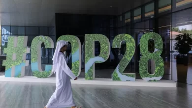 A person walks past a "#COP28" sign during The Changemaker Majlis, a one-day CEO-level thought leadership workshop focused on climate action, in Abu Dhabi, United Arab Emirates, October 1, 2023. REUTERS/Amr Alfiky