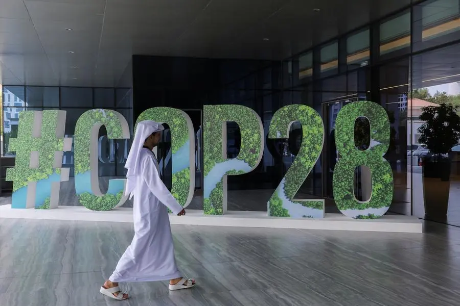 A person walks past a "#COP28" sign during The Changemaker Majlis, a one-day CEO-level thought leadership workshop focused on climate action, in Abu Dhabi, United Arab Emirates, October 1, 2023. REUTERS/Amr Alfiky