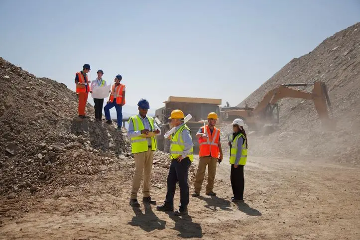 Image used for illustrative purpose. Business people and workers talking in quarry Source: Zawya.com