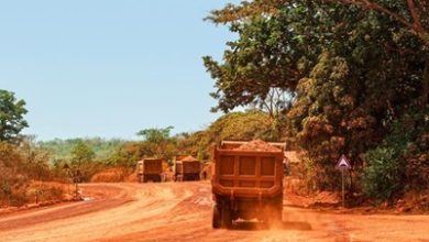 Trucks transporting bauxite along a mining hauling road in Guinea. Credit: Genevieve Campbell